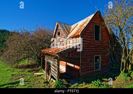 Abandoned two story house made from weatherboard and corrugated iron Stock Photo