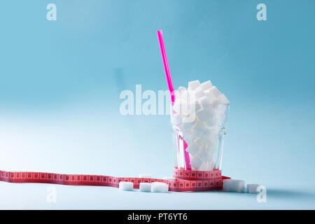 https://l450v.alamy.com/450v/pt6yt6/sugar-cubes-in-glass-with-measuring-tape-diabetes-and-sugar-overuse-concept-blue-background-with-copy-space-pt6yt6.jpg