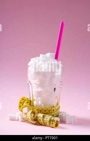 White sugar cubes in a measuring cup - Stock Image - C047/8141