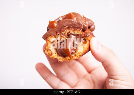 eclair with chocolate cream, hazelnuts and salty caramel Stock Photo