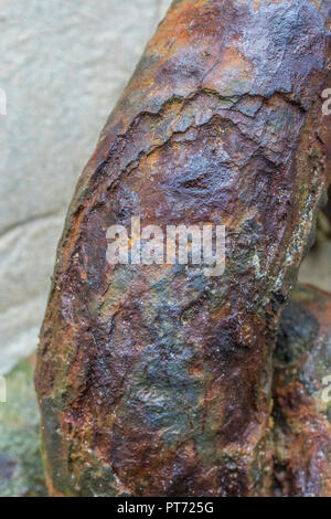Thick rust encrustation on very heavy duty mooring chain. Rust is a form of iron oxide. Metaphor for corrosion, weak link, weak point, weakness. Stock Photo