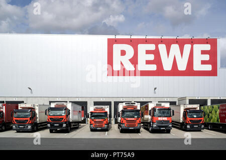 Trucks at REWE distribution center. REWE operates approximately 3,300 supermarkets in Germany. Stock Photo