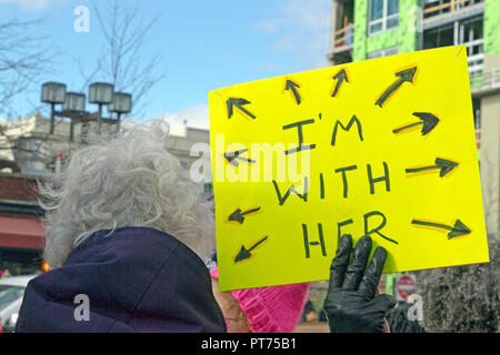 Asheville, North Carolina, USA – January 20, 2018: Older woman at the 2018 Women's March holds a sign that says 'I'M WITH HER' in downtown Asheville,  Stock Photo