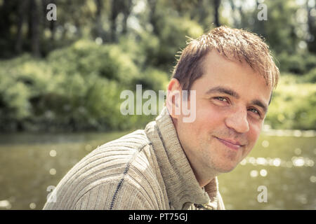 Cheerful happy man outdoors nature portrait rural lifestyle during sunny summer traveling camping holidays concept healthy lifestyle Stock Photo