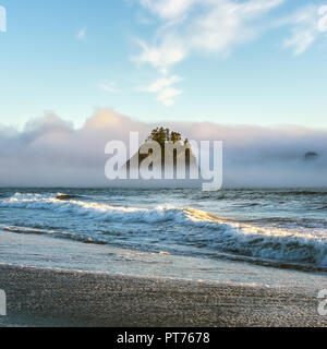 Famous Rialto Beach sea stacks surrounded by fog or clouds or mist on the evening, at sunset, Olympic National Park, Washington state Coast, USA. Stock Photo