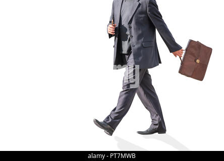 A man walks in a suit with a briefcase on an isolated background. Stock Photo