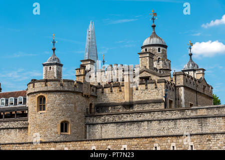 Detail of the Tower of London on a sunny day with one of the modern skyscrapers in the back Stock Photo
