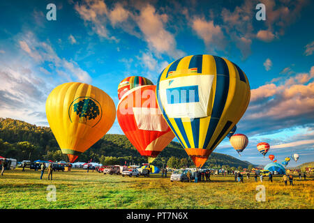 Stunning colorful hot air balloons preparing to rise in the early morning dawn, near Sovata resort, Romania, Transylvania, Romania, Europe Stock Photo