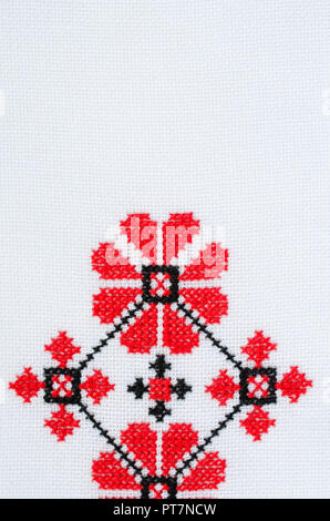 Element Handmade Embroidery on White Linen by Red and Black Cotton Threads. Design of Ethnic Textures. Pattern Craft Embroidery By Cross Stitch. Backg Stock Photo