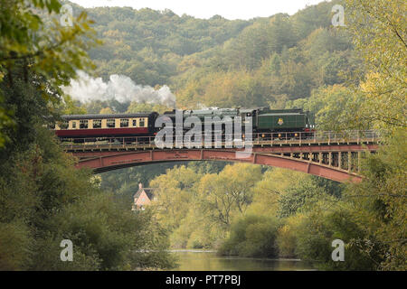 A BR Standard Class 7 70000 Britannia steam train travels across Victoria Bridge between Bewdley and Arley on the Severn Valley Railway, Worcestershire.