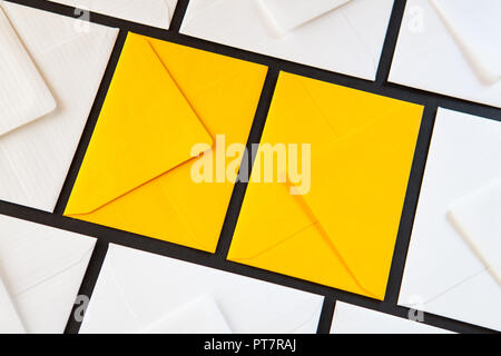 Composition with white and yellow, envelopes on the table. Different colored envelopes on the table. Stock Photo