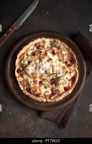 Turkey or Chicken leftover Tart Pie with pears, cheese and cranberries. Thanksgiving or Christmas turkey leftovers homemade quiche, copy space, top vi Stock Photo