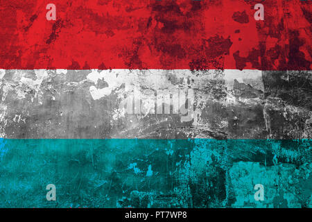 National flag of Luxembourg on the background of the old wall covered with peeling paint Stock Photo