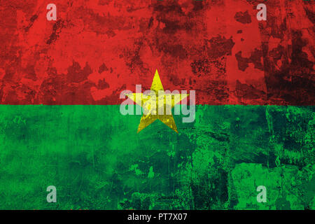 National flag of Burkino faso on the background of the old wall covered with peeling paint Stock Photo