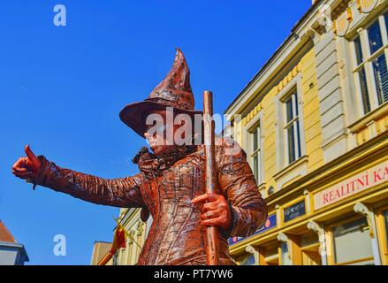 HUSTOPECE, CZECH REPUBLIC - OCTOBER 7, 2018: Living statue of witch. Live statue of sorceress. Living statue street performer. Stock Photo