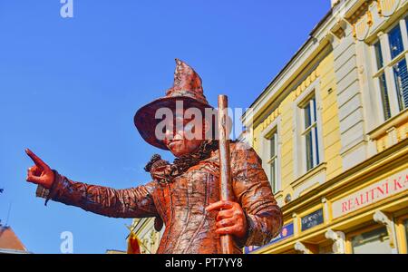 HUSTOPECE, CZECH REPUBLIC - OCTOBER 7, 2018: Living statue of witch. Live statue of sorceress. Living statue street performer. Stock Photo