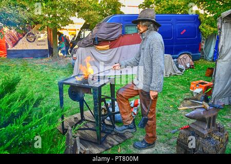HUSTOPECE, CZECH REPUBLIC - OCTOBER 7, 2018: Street performer as blacksmith.  Street performers can fool passersby and entertain tourists. Stock Photo