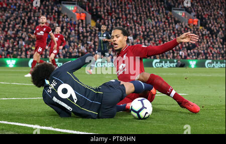 Liverpool's Virgil van Dijk (right) brings down Manchester City's Leroy Sane inside the box, resulting in a penalty, during the Premier League match at Anfield, Liverpool. Stock Photo