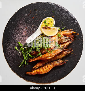 Grilled shrimp skewers. Seafood, shelfish. Shrimps Prawns skewers with herbs, garlic and lemon. Stock Photo