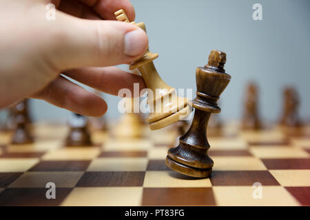 hand of businessman moving chess figure in competition success play. strategy, management or leadership concept Stock Photo