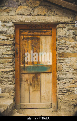 Photo of a wooden door of an abandoned, rickety house, and a broken lock, taken at Tiger Falls, Uttarakhand, India Stock Photo