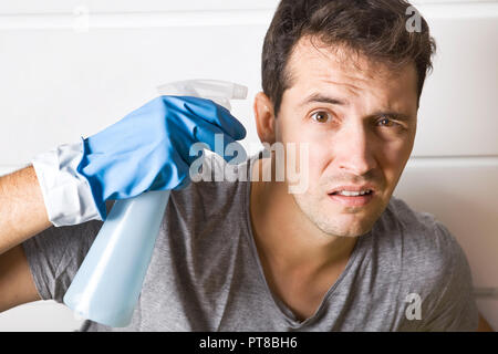Stressed young men during cleaning. He has enough housekeeping Stock Photo