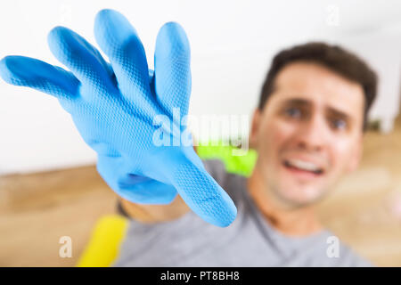 Stressed and screaming young men during cleaning. He has enough housekeeping Stock Photo