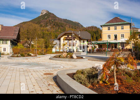 Fuschl am See, Austria - October 26, 2017: Dorfplatz central square of austrian town Fuschl am See. People sitting on outdoor terrace of restaurant on Stock Photo