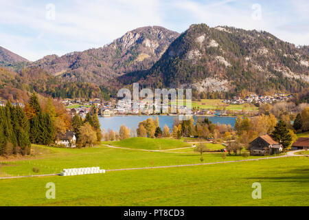Beautiful view of alpine meadow, Fuschlsee lake, mountains and austrian town Fuschl am See on a sunny autumn day Stock Photo