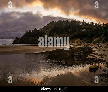 Beautiful and dramatic sunset over Agate Beach and Little Schooner Creek and Yaquina Head, Newport, Oregon Coast, USA. Stock Photo