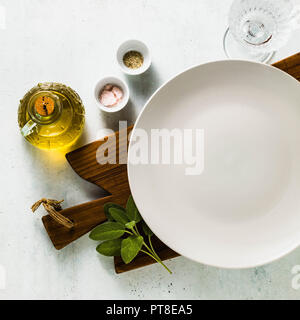 table setting. empty plates, spices, cutlery and olive oil. place to write text. copy space. collage template Stock Photo