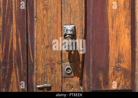metal knocking knob on wooden door closeup Stock Photo