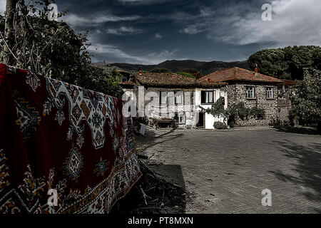 Birgi, hidden in a green geography on the cool slopes of Bozdağlar, can be seen from centuries-old plane trees and walnut trees with high stone walls, Stock Photo