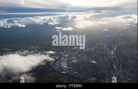 aerial view of Cork city in the Rebublic of Ireland through clouds and hazy evening sun Stock Photo