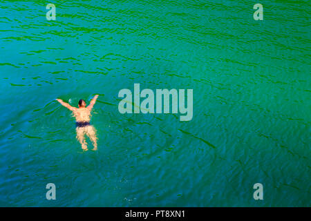 Man swimming in a lake. Stock Photo