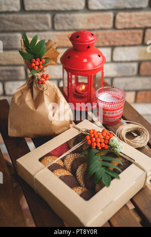 Set of cookies in gift boxes on dark wooden table Stock Photo
