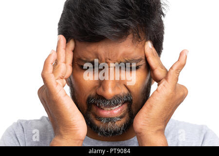 Close-up of indian male person touching temples with both hands as migraine concept isolated on white background Stock Photo