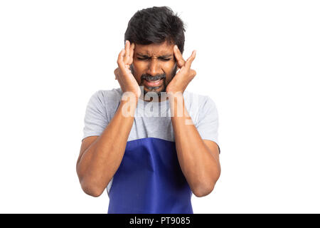 Stressed supermarket or hypermarket male employee having a migraine touching temples with both hands isolated on white background Stock Photo