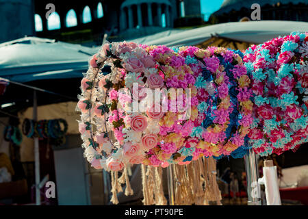 colorful set of crowns for sale made of fake flowers Stock Photo