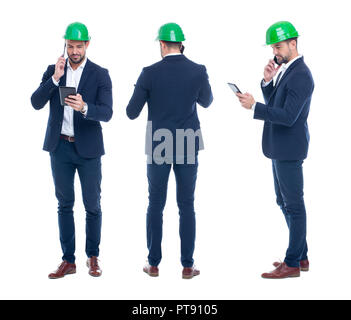 Young engineer with tablet calling by phone, front, side, rear view, isolated on white Stock Photo
