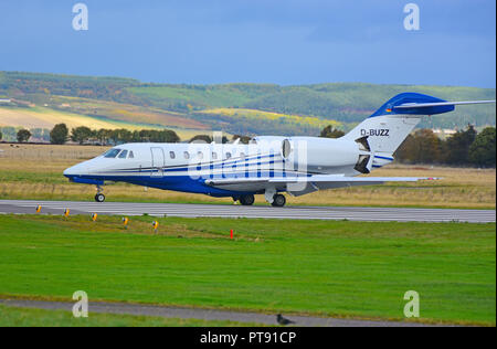 Taxiing on arrival at Inverness Dalcross airport is German registered Cessna Citation 750 X. D-BUZZ. Stock Photo