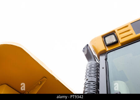 Detail of rear dumper heavy machinery. Cabin isolated on white sky. Stock Photo