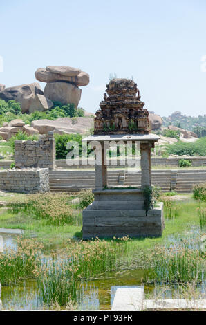 An artistic pavilion in the centre of the pushkarani - a public utility-stepped water tank at Krishnapura, Hampi, Karnataka, India Stock Photo