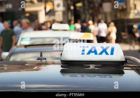 A taxi sign with blue letter on a taxi car in Amsterdam, Netherlands. Stock Photo