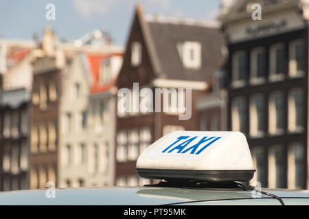 A taxi sign with blue letter on a taxi car in Amsterdam, Netherlands. Stock Photo