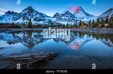Mount Assiniboine, also known as Assiniboine Mountain, is a pyramidal peak mountain located on the Great Divide, in British Columbia/Alberta. Stock Photo