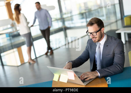 Young business man leadership of big successful enterprise is checking the status of bank account Stock Photo