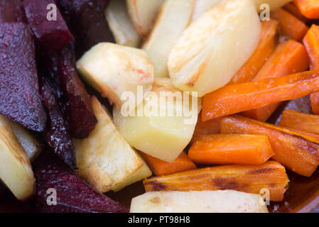 baked root vegetables on plate Stock Photo