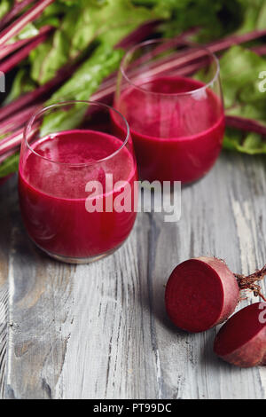Detox juice with freshly picked bunch of beetroot. Fresh beets on a wooden table. Stock Photo