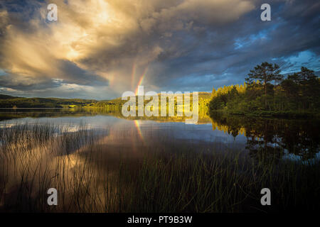 Beautiful rainbow after the storm, seen by the Jonsvatnet lake near Trondheim, Norway. Stock Photo